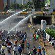 Opposition activists clash with the riot police during a march against Venezuelan President Nicolas Maduro in Caracas, on May 26, 2017