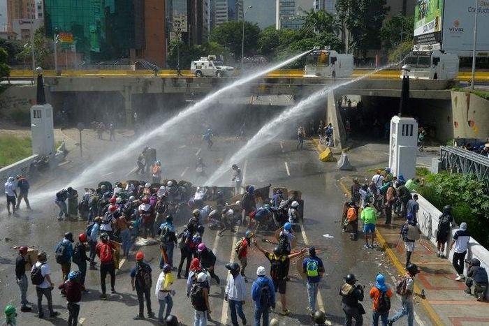 Opposition activists clash with the riot police during a march against Venezuelan President Nicolas Maduro in Caracas, on May 26, 2017