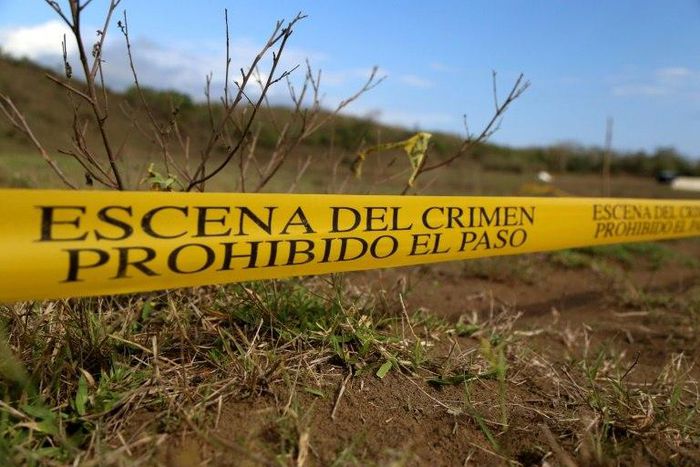 Mass graves are cordoned off by police on the outskirts of Veracruz city, Veracruz state, on March 16, 2017