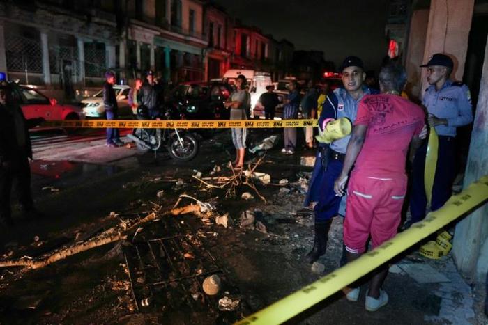 Police cordoned off a street in Havana's Luyano neighborhood, an area hard hit by the rare tornado to strike the Cuban capital