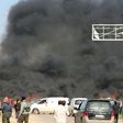 Smoke billows from the site of a suicide car bombing in Rashidin, west of Aleppo, that targeted buses carrying Syrian evacuees on April 15, 2017