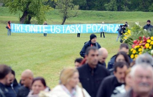 Activists hold an anti-fascist banner at a ceremony for the death camp victims of Croatia's former Nazi-allied regime