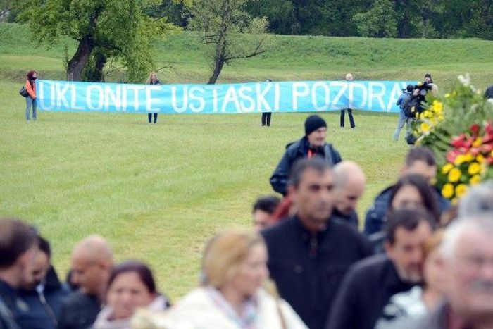 Activists hold an anti-fascist banner at a ceremony for the death camp victims of Croatia's former Nazi-allied regime
