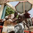 Children orphaned by Boko Haram Islamists play on a spinning wheel at an abandoned amusement park in Maiduguri, Nigeria