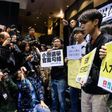 Pro-democracy protesters (R) shout slogans against former Hong Kong chief secretary and leadership hopeful Carrie Lam (not seen) before the start of a press conference by Lam in Hong Kong on February 27, 2017
