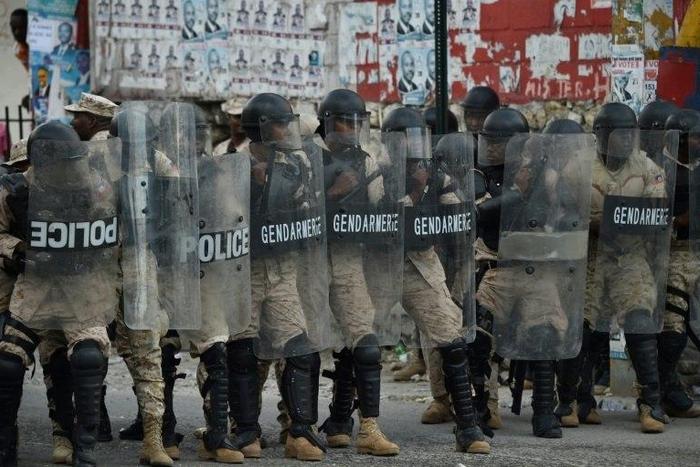 Haitian police confront demonstrators protesting the election of Jovenel Moise as new president of Haiti in Port-au-Prince