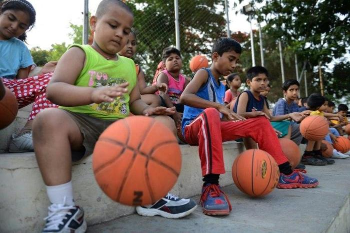 Young Indian children take part in a basketball summer training camp in Hyderabad