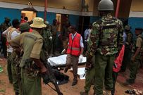 Police officers stand by dead bodies after an attack by Islamist militants from the Somali group al Shabaab in Mandera, Kenya, October 6, 2016.