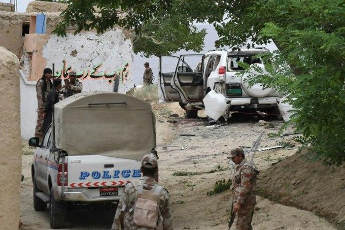 Pakistani security officials examine the site of a powerful explosion near Quetta on May 12, 2017