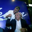 Ecuadorian President Rafael Correa (L) hugs Lenin Moreno during a post-election rally in Quito, on February 19, 2017