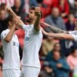 Swansea City's striker Fernando Llorente (C) celebrates with midfielder Gylfi Sigurdsson (L) and defender Alfie Mawson (R) after scoring the opening goal of the English Premier League football match against Sunderlan May 13, 2017