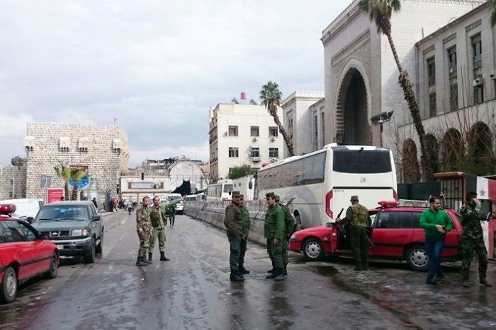 Syrian security forces cordon off the area following a suicide at a courthouse in Damascus on March 15, 2017