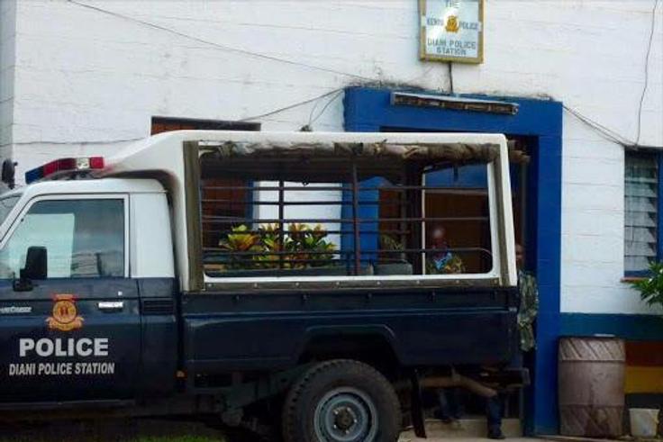 A police vehicle parked outside a police station
