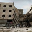 People inspect a hospital, damaged following an air strike a rebel-controlled town in the eastern Ghouta region on the outskirts of the capital Damascus on May 1, 2017