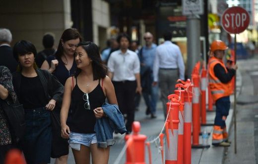 Pedestrians in Sydney's central business district on April 19, 2017. Australia's decision to scrap a visa programme for temporary foreign workers won both praise and criticism