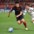 Kashima Antlers defender Naomichi Ueda (left) competes for the ball with Muangthong United's Chanathip Songkrasin during their AFC Champions League match in Kashima on May 10, 2017