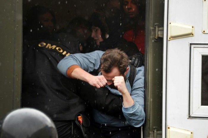 Riot police officers detain participants during a rally against President Alexander Lukashenko's rule and a controversial new tax on "spongers" - those who work less than six months a year - in Minsk on March 25, 2017