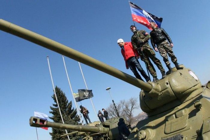 Pro-Russian activists stand on top of a tank outside a museum in Donetsk, Ukraine, in March 2014