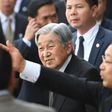 Japan's Emperor Akihito (C) flanked by security men arrives at Phu Bai airport in Vietnam's central city of Hue as they prepare to depart for Thailand, ending their six-day long royal visit in the communist country on March 5, 2017