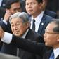 Japan's Emperor Akihito (C) flanked by security men arrives at Phu Bai airport in Vietnam's central city of Hue as they prepare to depart for Thailand, ending their six-day long royal visit in the communist country on March 5, 2017