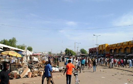 Residents gather near the scene of a suicide bomb attack on a market in Maiduguri, after two young girls blew themselves up, killing themselves and wounding at least 17 others, in December 2016