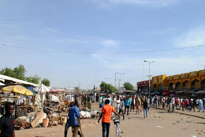 Residents gather near the scene of a suicide bomb attack on a market in Maiduguri, after two young girls blew themselves up, killing themselves and wounding at least 17 others, in December 2016