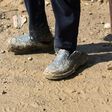 Displaced Iraqi children from Mosul walk in the mud towards refugee camps on March 24, 2017