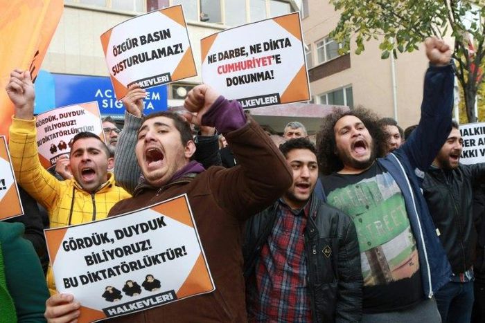 Participants hold placards reading, "Free press can't be silenced" (C) outside the office of Turkish newspaper Cumhuriyet in Ankara in 2016