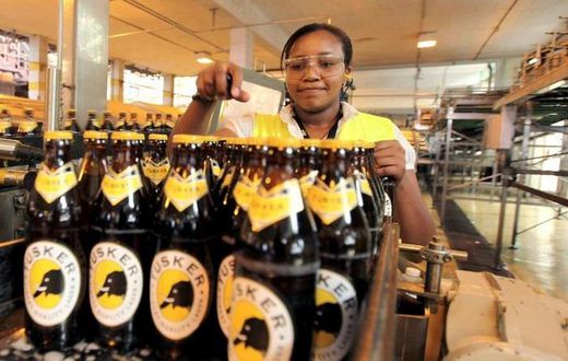 A file photo of an employee inspecting beer at an East African Breweries Ltd factory.