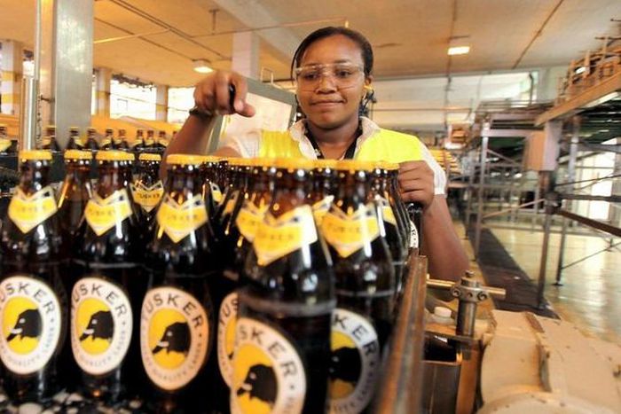 A file photo of an employee inspecting beer at an East African Breweries Ltd factory.