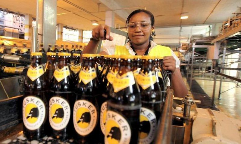 A file photo of an employee inspecting beer at an East African Breweries Ltd factory.