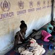 South Sudanese refugees wait outside their tent in Kakuma refugee camp, northwestern Kenya, on September 6, 2010