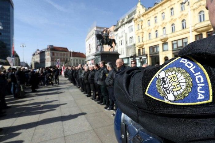 A police officer stands by as supporters of a Croatian far-right party gather in Ban Jelacic Square in downtown Zagreb on February 26, 2017