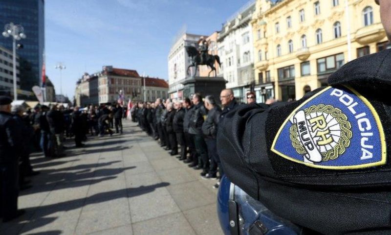 A police officer stands by as supporters of a Croatian far-right party gather in Ban Jelacic Square in downtown Zagreb on February 26, 2017