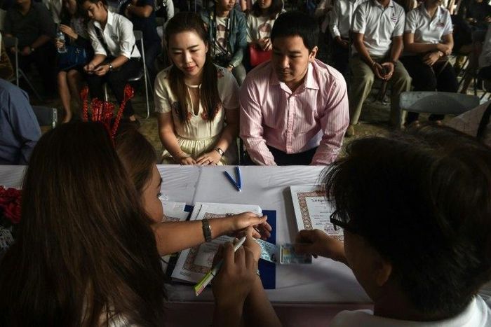 A couple registers their marriage on Valentine's Day at the central post office in Bang Rak, or "Love Village", district in Bangkok on February 14, 2017