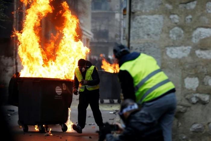 "Yellow vest" protesters in the northern French city of Rouen, where a journalist was beaten by a crowd on Saturday