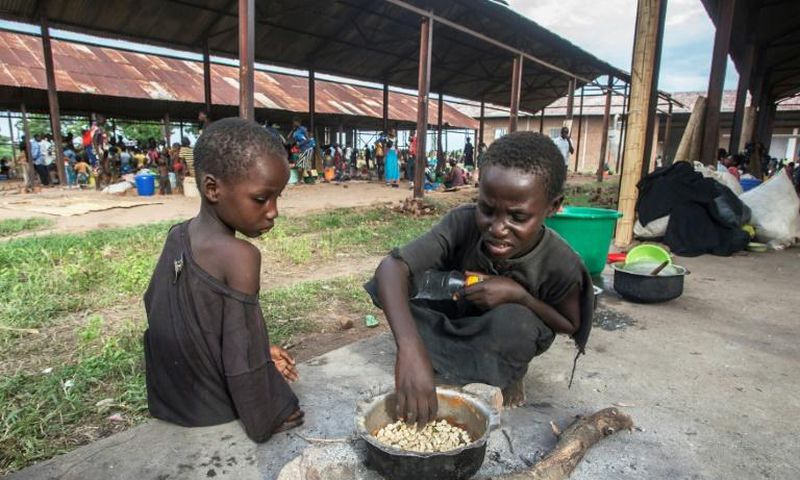 Homeless: Children cook corn at a camp for displaced people in Bangula, southern Malawi