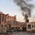 Smoke billows in Aleppo's Bustan al-Basha district on November 28, 2016, during Syrian pro-government forces assault to retake the entire city from rebels