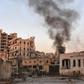 Smoke billows in Aleppo's Bustan al-Basha district on November 28, 2016, during Syrian pro-government forces assault to retake the entire city from rebels