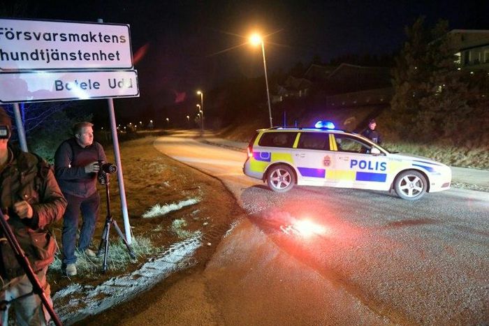 Journalists work at a police checkpoint in Marsta, north Stockholm, on April 7, 2017 after a man suspected of being involved in the truck attack in central Stockholm was arrested