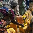 Women collect water from a water point at the Internally Displaced People (IDP) camp, in Bama, on December 8, 2016