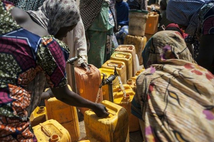 Women collect water from a water point at the Internally Displaced People (IDP) camp, in Bama, on December 8, 2016