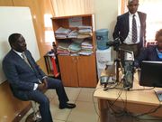 ODM leader Raila Odinga having photo taken during the application of the E-Passport (Twitter)
