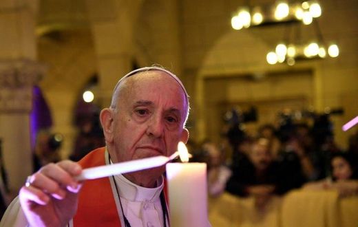 Pope Francis lights a candle at Cairo's Saint Peter and Saint Paul church, the target of a December suicide bomb attack that killed 29 people, on April 28, 2017