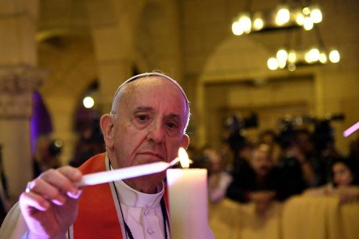 Pope Francis lights a candle at Cairo's Saint Peter and Saint Paul church, the target of a December suicide bomb attack that killed 29 people, on April 28, 2017