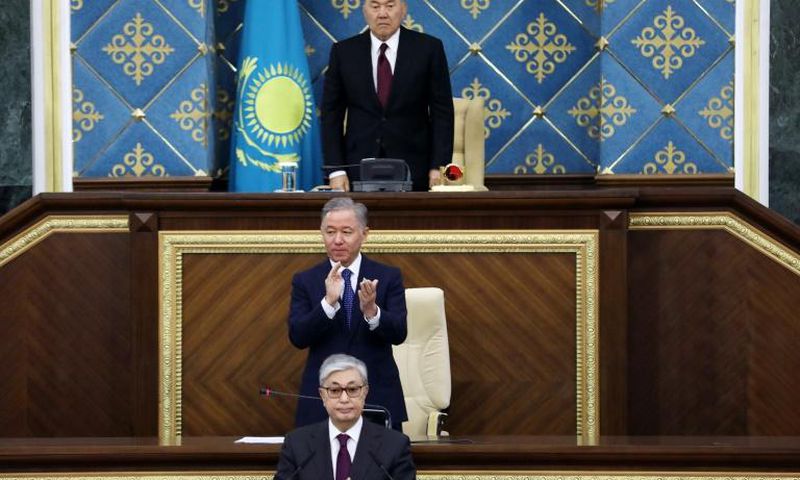 Kazakhstan's new interim president Kassym-Jomart Tokayev (bottom) was sworn, taking over from long-time former president Nursultan Nazarbayev (top)