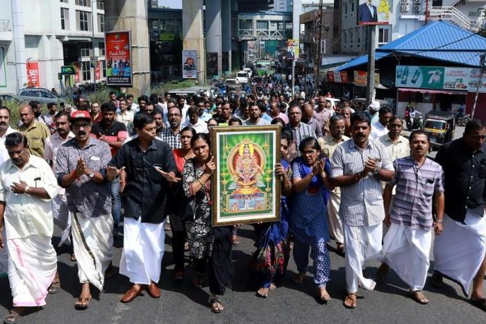 Protests broke out after police escorted two women into a controversial temple in Southern India