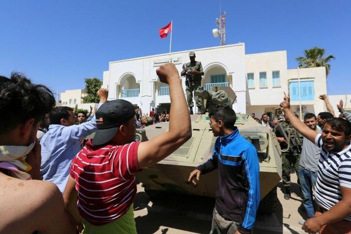 Tunisian protesters gather outside the Tataouine governor's office on May 22, 2017, in solidarity with a sit-in outside an oil and gas installation in the same province to demand jobs