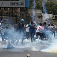 Demonstrators protesting against President Nicolas Maduro's government, for the fifth time in the past week, clash with riot police in Caracas, on April 10, 2017