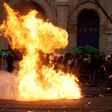 French firefighters try to extinguish a burning barricade as students gather during a demonstration outside the "Lycee Voltaire" secondary school in Paris, on February 23, 2017